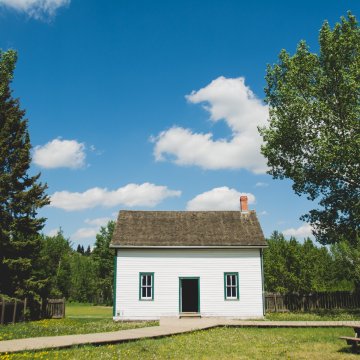 an older house that has the picture taken from the driveway